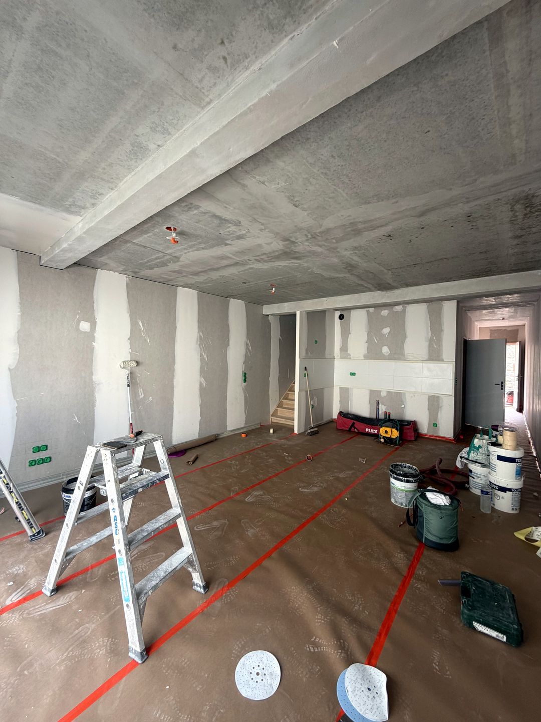 Avant travaux à Saint-Jean-Pla-de-Corts : séjour en plaques de plâtre avec bandes apparentes, plafond brut, sol protégé